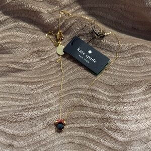 Kate Spade Gold Necklace with Dark Red Accent